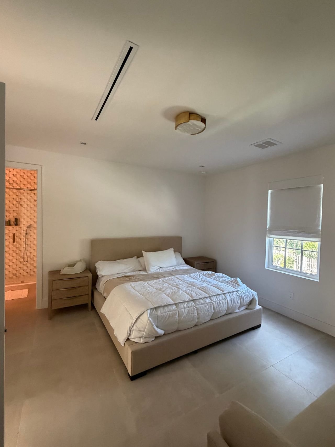 Bright primary bedroom with recessed lighting
