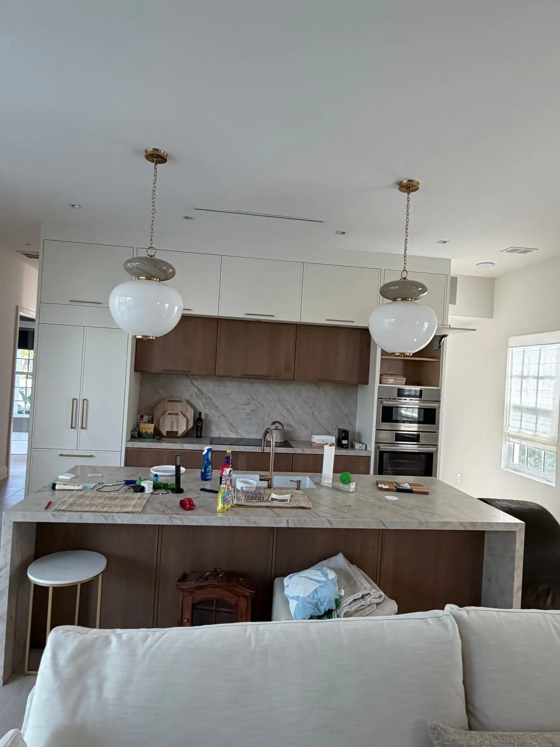 Custom kitchen with walnut cabinets, stone backsplash and island seating