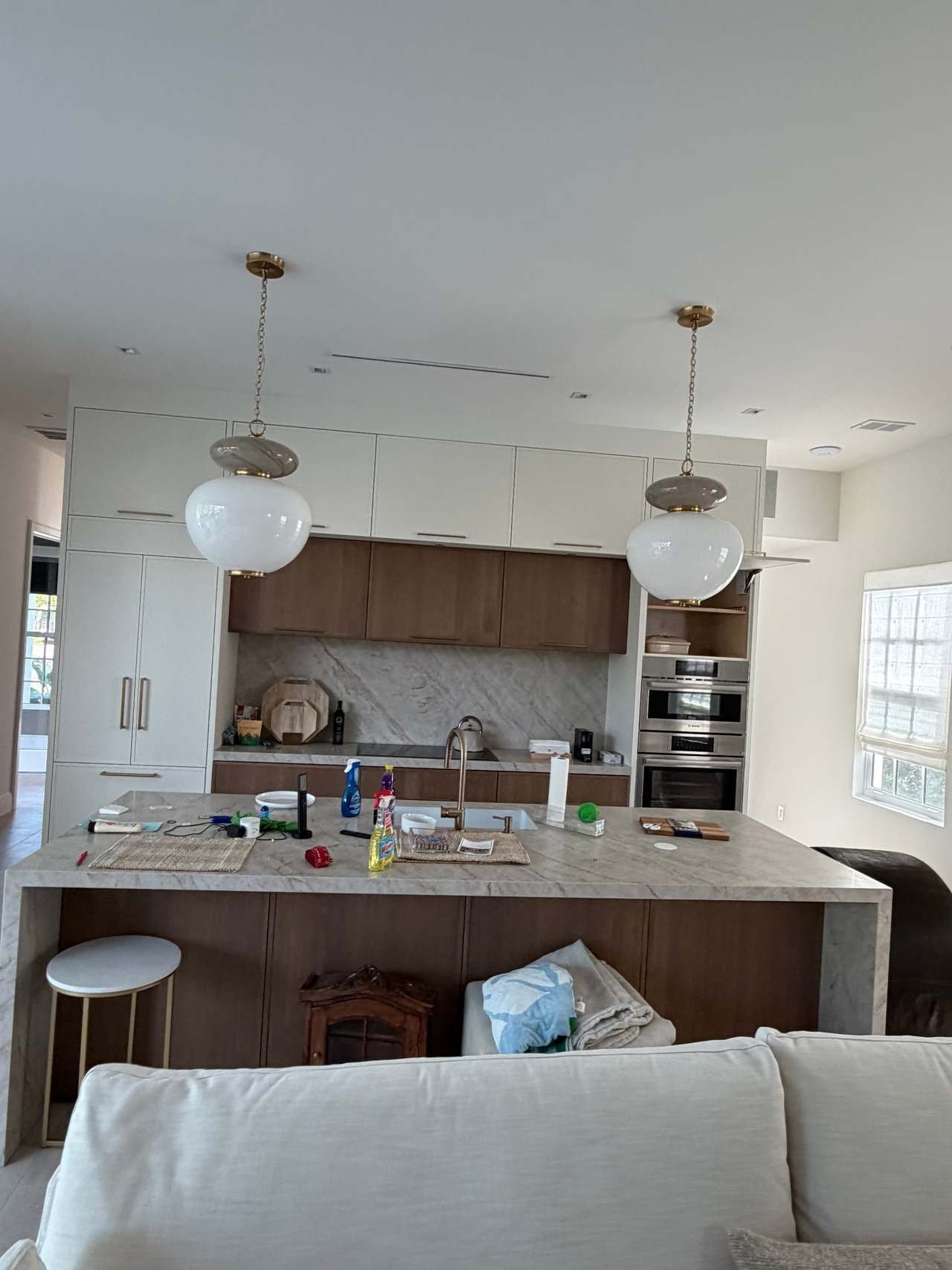 Custom kitchen with walnut cabinets, stone backsplash and island seating