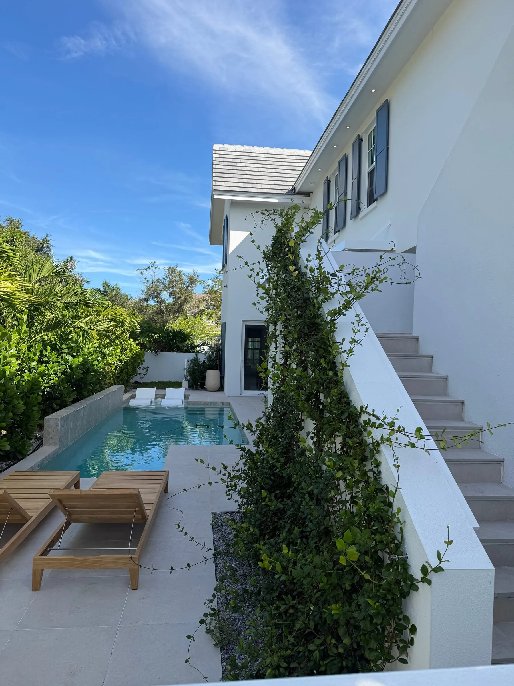 Lap pool and sun deck at a coastal custom home built by Palm Bay Construction Group