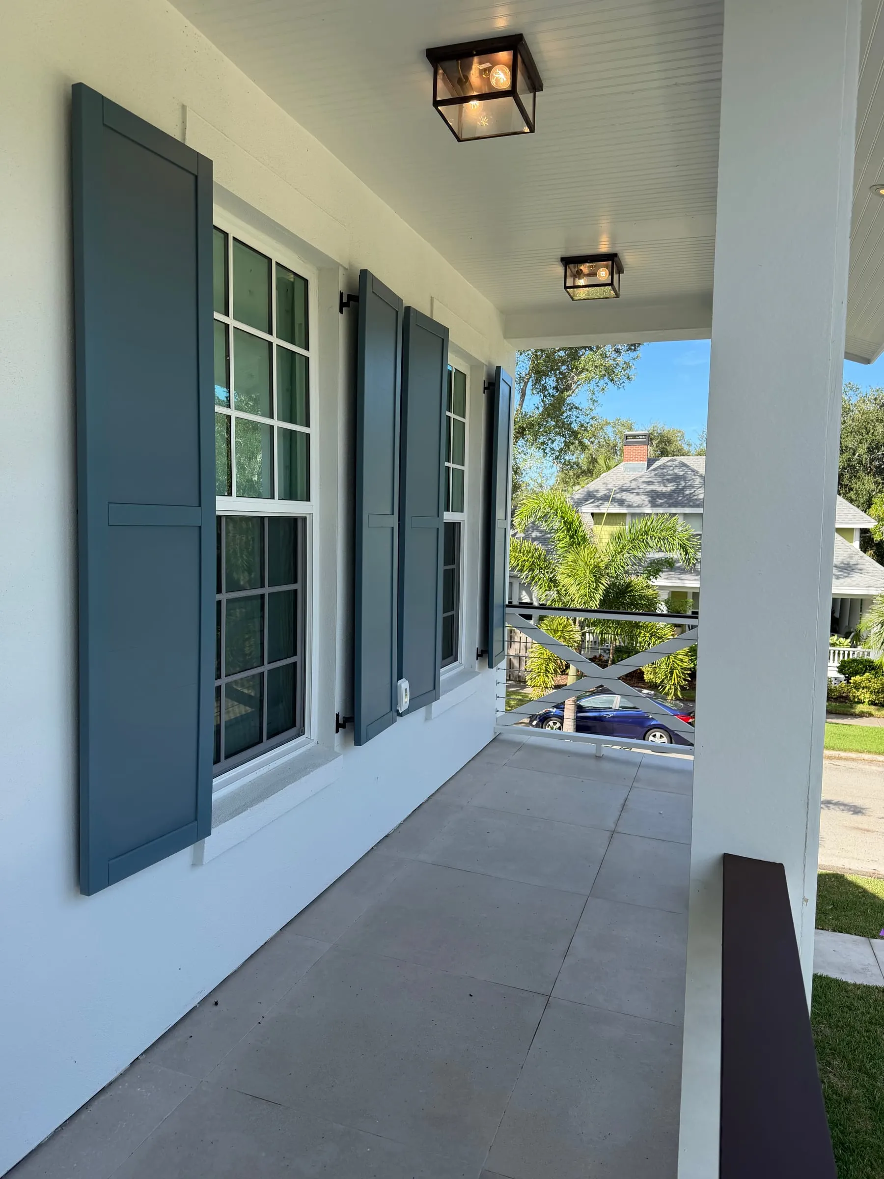 Covered front porch with lantern lights and shuttered windows