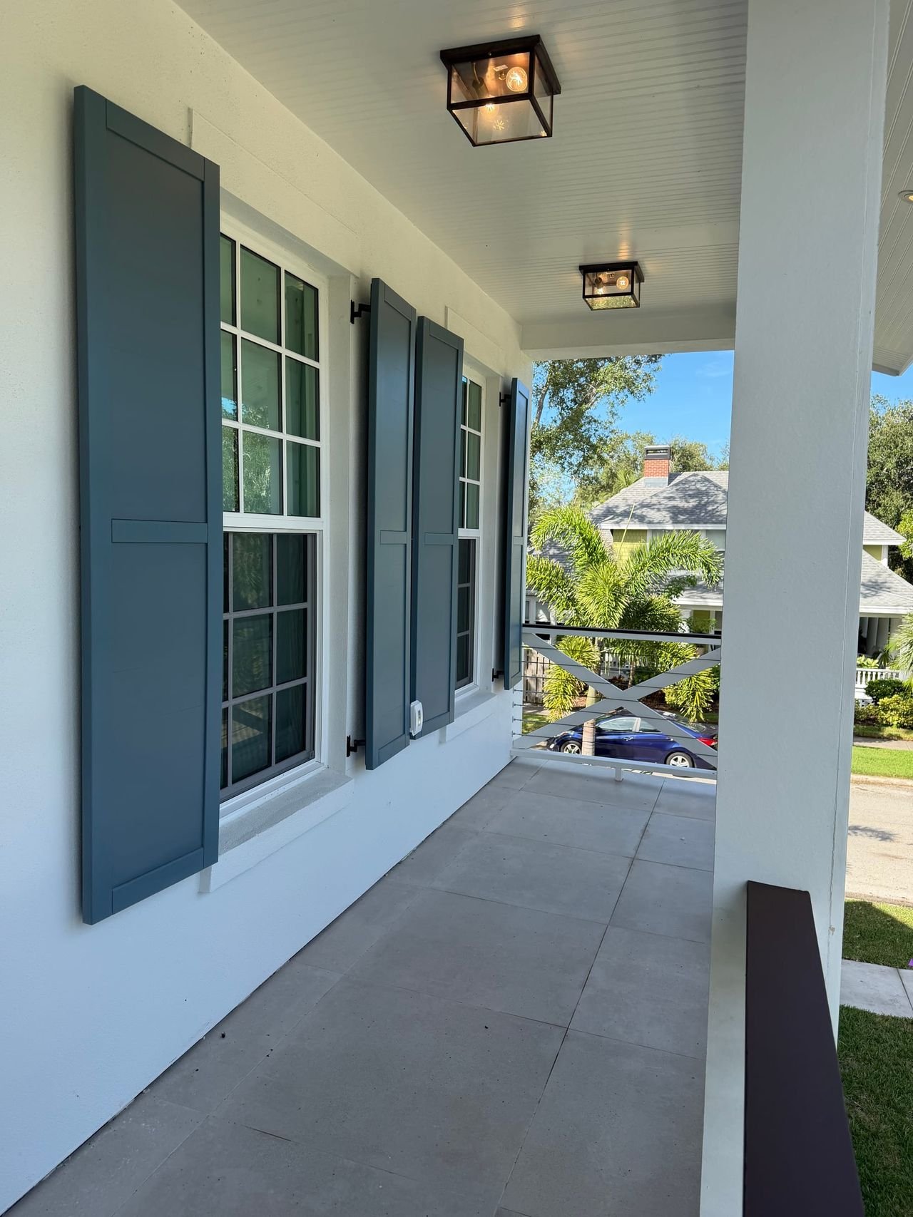 Covered front porch with lantern lights and shuttered windows
