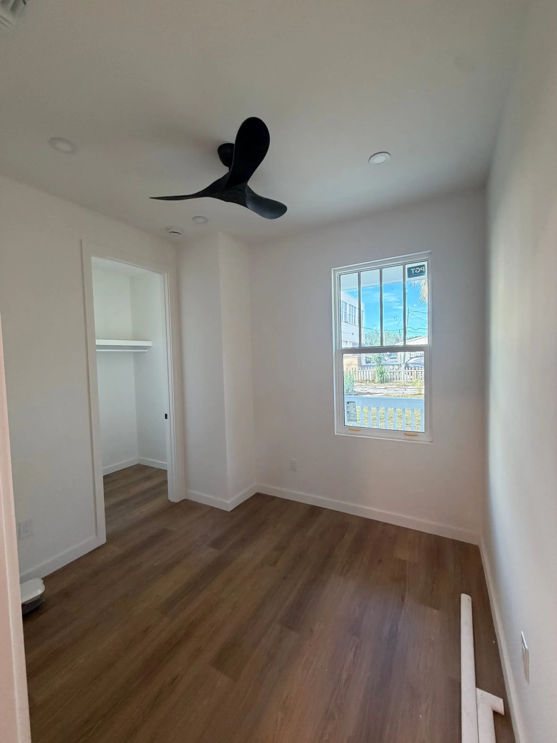 Bedroom with wood-look flooring and ceiling fan