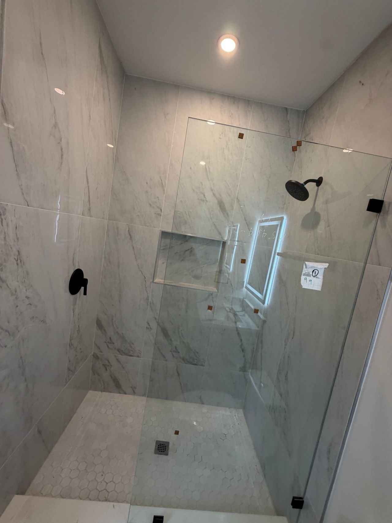Walk-in shower with marble-look porcelain tile