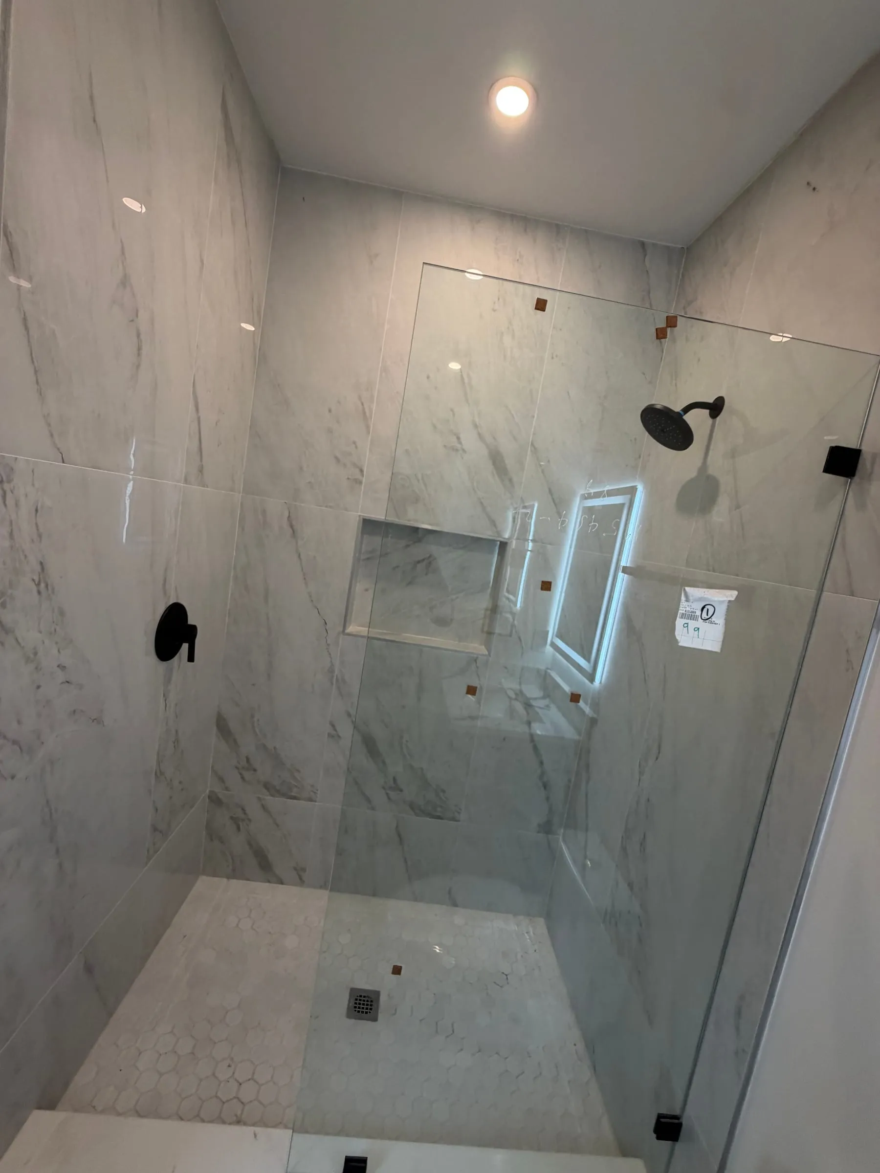 Walk-in shower with marble-look porcelain tile