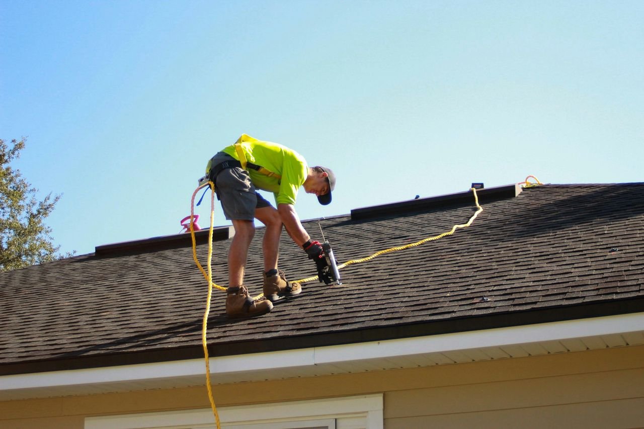 Roofer installing a new roof on a residential home